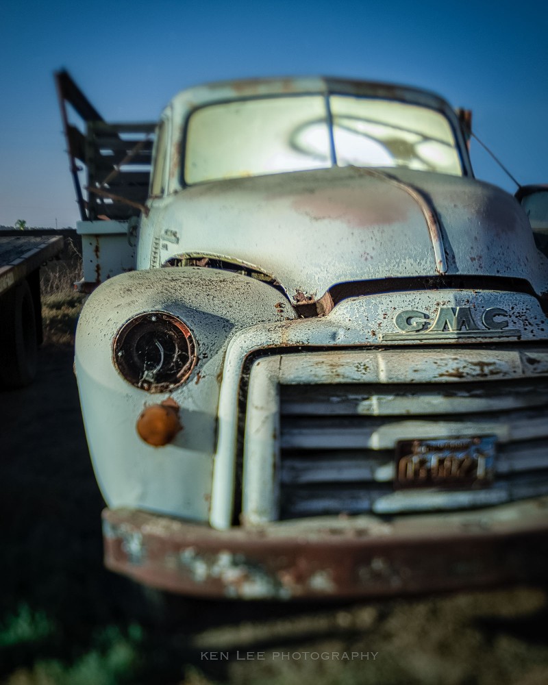 A ghostly view of a vintage GMC truck with an odd tilt-shift blur effect courtesy of a Lensbaby lens.